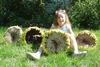 My daughter sitting with some sunflower heads